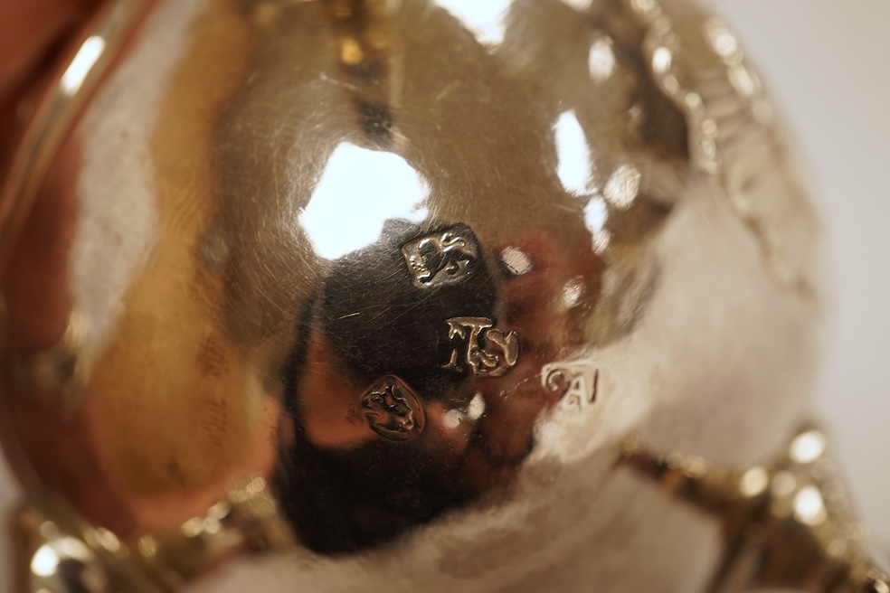 A late George II silver baluster cream jug, with later embossed decoration, on three hoof feet, Samuel Meriton I London, 1756, 10.6cm, 3.3oz.